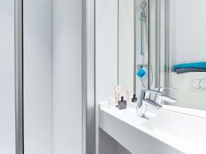 a bathroom with a sink and a mirror at hotelF1 Montpellier Sud in Lattes +73 photos