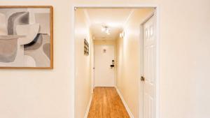 a hallway with a white door and a painting on the wall at Downtown 1 BR Condo near Convention Center in Seattle