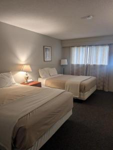 a hotel room with two beds and a window at Lakeside Motel in Williams Lake