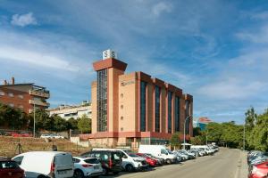 a building with a sign on the top of a parking lot at Sercotel Porta Barcelona in Sant Just Desvern +35 photos