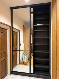 a mirror in a room with a closet at Studio apartment in Slezská Ostrava +1 photo