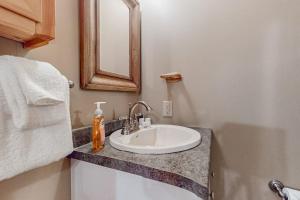 a bathroom with a sink and a mirror at The Loft at Pine Rock in Weston +48 photos