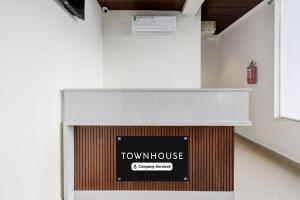 a counter with a sign that reads town house at Super Townhouse Badangpet Crossway Hyderabad Formerly Balapur in Surūrnagar