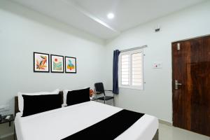 a white bedroom with a bed and a window at Super Townhouse Badangpet Crossway Hyderabad Formerly Balapur in Surūrnagar