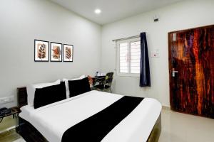a bedroom with a large white bed and a window at Super Townhouse Badangpet Crossway Hyderabad Formerly Balapur in Surūrnagar