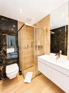 a bathroom with a shower and a toilet and a sink at Golden Trio Villas in Ząb +39 photos