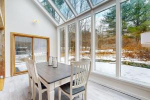 a dining room with a wooden table and chairs at Whistling Peak in Wilmington