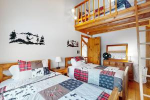 a bedroom with two beds and a staircase at Whistling Peak in Wilmington