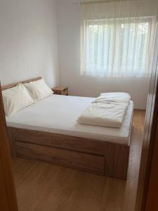 a large bed in a bedroom with a window at Una Relax Apartment - Naturally Cool - North-Facing - Near the River in Bosanska Krupa