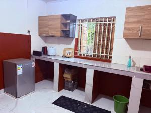 a kitchen with a counter top and a refrigerator at Logis Baobab in Morondava