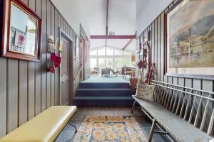a hallway with a bench and stairs in a house at Treetop Chalet in Peru