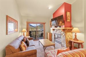 a living room with a couch and a fireplace at Red Hawk Lodge #2308 in Keystone