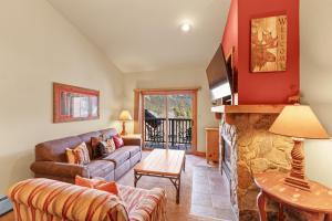 a living room with a couch and a fireplace at Red Hawk Lodge #2308 in Keystone