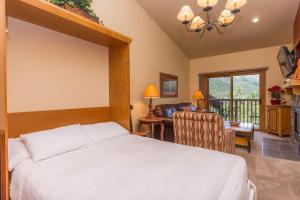 a bedroom with a bed and a living room at Red Hawk Lodge #2308 in Keystone