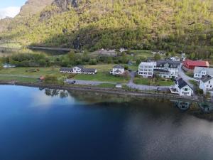 an aerial view of a house next to a body of water at Hjelle Hotel in Hjelle