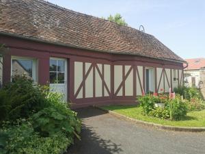 a red and white building with a garage at La petite FloPée in Le Mont-Saint-Adrien