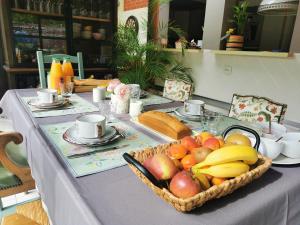 a table with a basket of fruit on it at La petite FloPée in Le Mont-Saint-Adrien