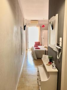 a bathroom with a sink and a bed in a room at Eleana Apartments in Hersonissos +126 photos