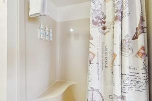 a bathroom with a shower curtain and a sink at Bomo Hacienda in Castleton +57 photos