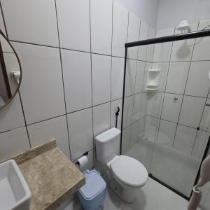 a bathroom with a toilet and a sink and a shower at New Center Hotel in Carolina +44 photos