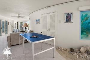 a blue ping pong table in a living room at Turtle Beach 5BR Snorkeling Kayaks & Family Entertainment in Providenciales