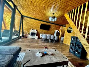 a living room with a table and some speakers at Cabana AxD in Cotorăşti