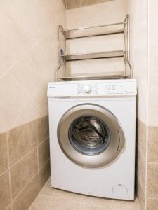 a washer and dryer in a bathroom at SunsetApartment in Siviri