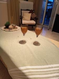two wine glasses sitting on top of a table at Akratas Brothers House in Akrata +8 photos