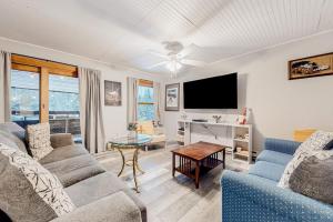 a living room with two couches and a tv at Pico Mountain Perch, Unit B22 in Mendon