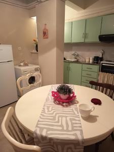 a kitchen with a table with a bowl of flowers on it at Akratas Brothers House in Akrata