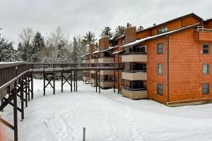 a building with snow on the ground in front of it at Pico Mountain Perch, Unit B22 in Mendon