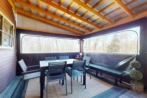 a patio with a table and chairs and a bench at SoMoguly in Mount Holly