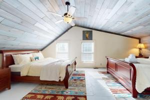a bedroom with a bed and a ceiling fan at SoMoguly in Mount Holly