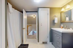 a bathroom with a sink and a shower with a mirror at SoMoguly in Mount Holly +57 photos