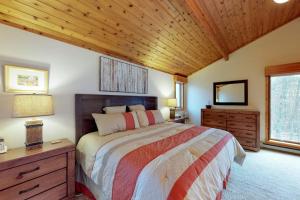 a bedroom with a bed and a wooden ceiling at South Hill Lodge in Ludlow