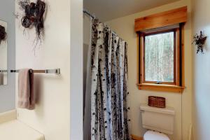 a bathroom with a shower curtain and a window at South Hill Lodge in Ludlow +56 photos