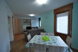 a living room with a table and a couch at Casa Debora in Valdidentro