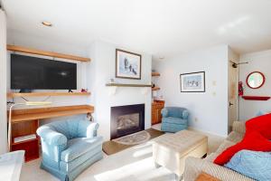 a living room with two chairs and a fireplace at A Warren Beauty in Warren