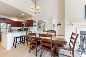 a kitchen and dining room with a wooden table and chairs at Winterplace Getaway in Ludlow