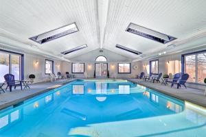 a large swimming pool with blue water in a building at Winterplace Getaway in Ludlow