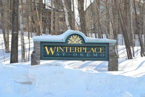 a sign for the entrance to the winter landscape atorenagency at Winterplace Getaway in Ludlow