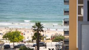 a view of the beach from a building at The Surf - Rocha Tower in Portimão