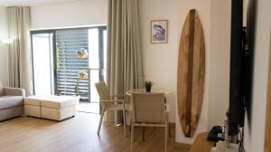 a living room with a table and a couch at The Surf - Rocha Tower in Portimão