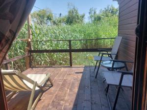 two chairs on a deck with a view of a field at Apartman Dva Dječaka in Ulcinj