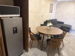 a living room with a table and a refrigerator at Loft Elena en ValQuirico in Santeagueda +24 photos