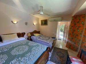 a bedroom with two beds and a window at EL Fouly Villa beach front -North Coast فيلا لمة العيله الفولي - سيدي كرير - الساحل الشمالي in Abû Zeira +40 photos