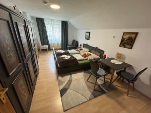 a bedroom with a bed and a table in a room at Steinadler Apartments Quiet Location Garden, Private Parking Pet Friendly in Murau
