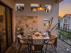 a dining room with a table and chairs on a balcony at Loft in Kruce in Kruče +15 photos