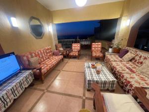 a large living room with couches and a table at EL Fouly Villa beach front -North Coast فيلا لمة العيله الفولي - سيدي كرير - الساحل الشمالي in Abû Zeira