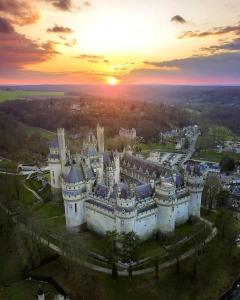 an aerial view of a castle at sunset at Château Compiegne Duplex et parking in Compiègne